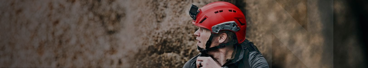 Person wearing a red Team Wendy SAR Tactical helmet against a textured wall