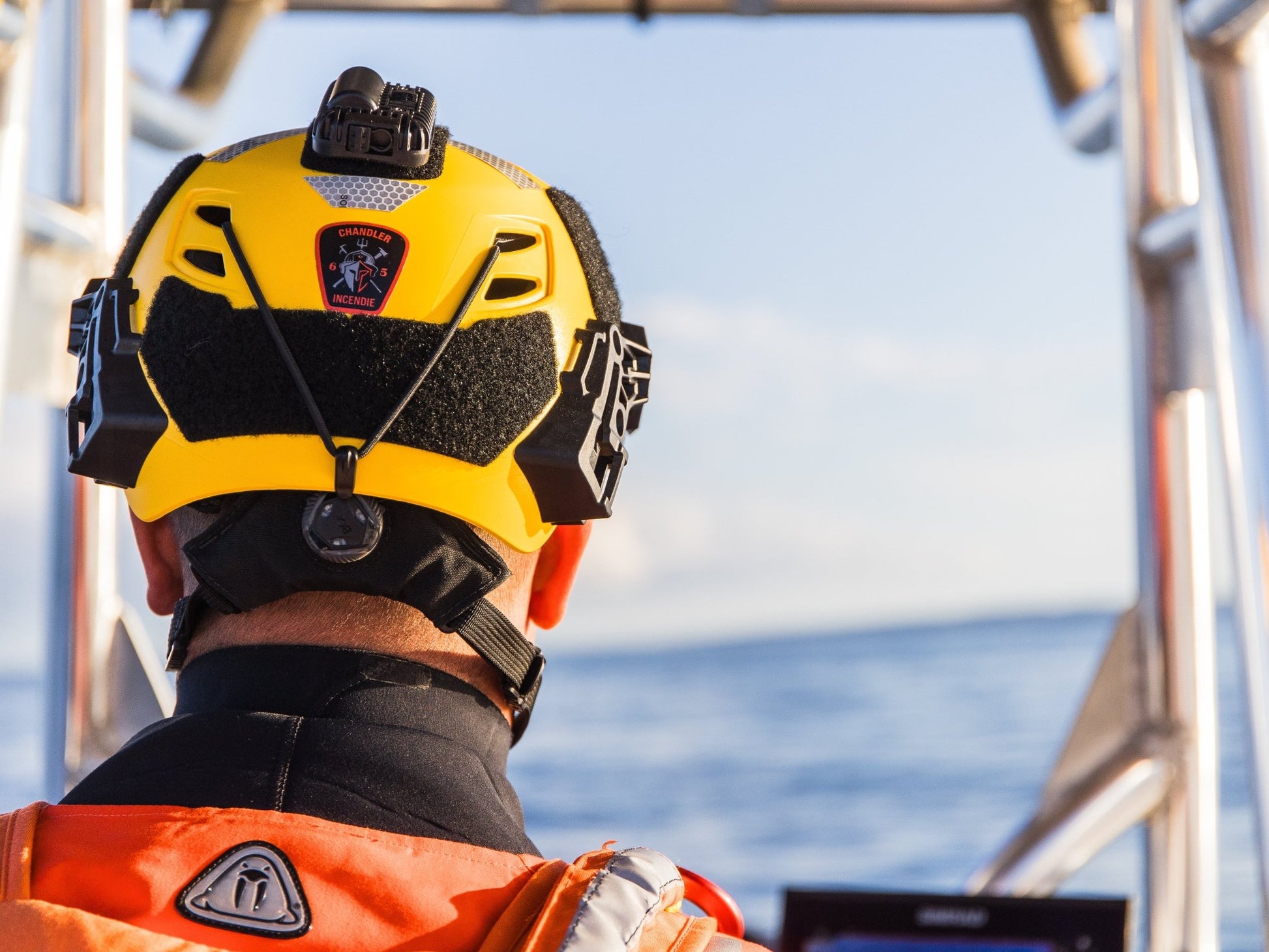 Man wearing Yellow Team Wendy Helmet on a boat in the water